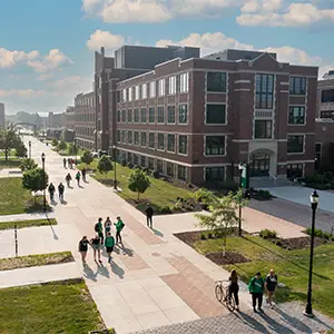 students walking by o'kelly hall in the spring 
