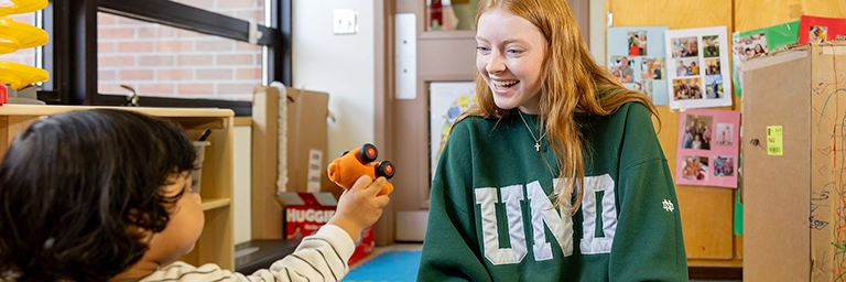 uclc staff member plays with child